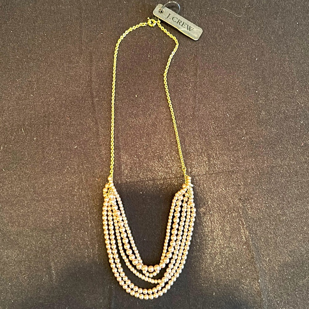 NWT mixed media necklace featuring 5 strands of pink-tinged pearls + brass chain